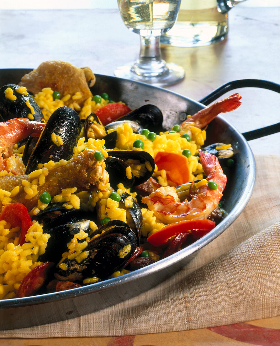 Vegetables stir fried with saffron paella, meat, shrimp and mussels