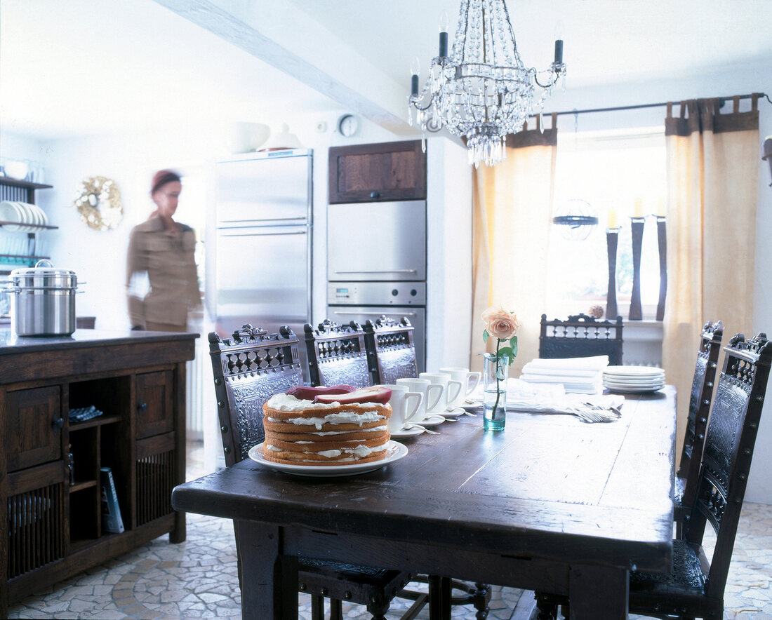 Dining table with dark wood furniture and stainless steel appliances