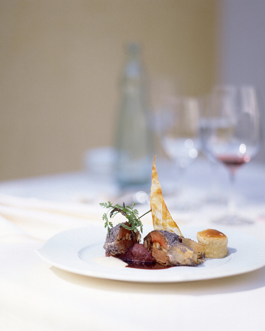 Pork with gewurzteig, vanilla souffle, potato and red cabbage puree on plate