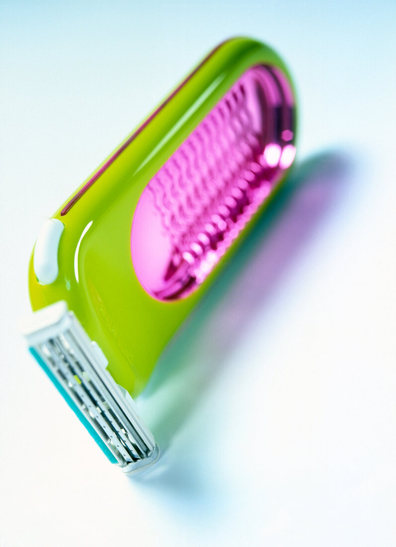 Close-up of wet razor used for hair removal in pop colours 
