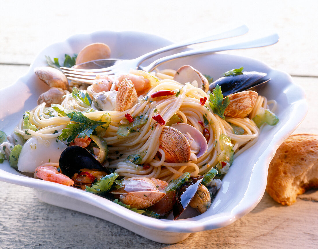 Spaghetti with seafood sauce in deep serving dish