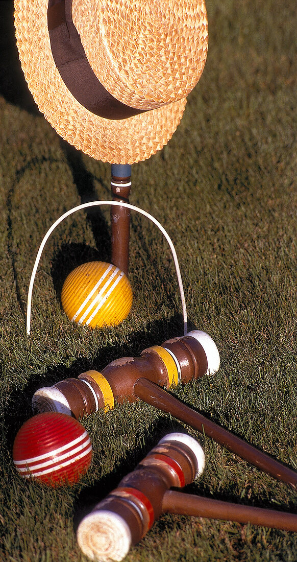 Gate ball stick, balls and sun hat on grass, California