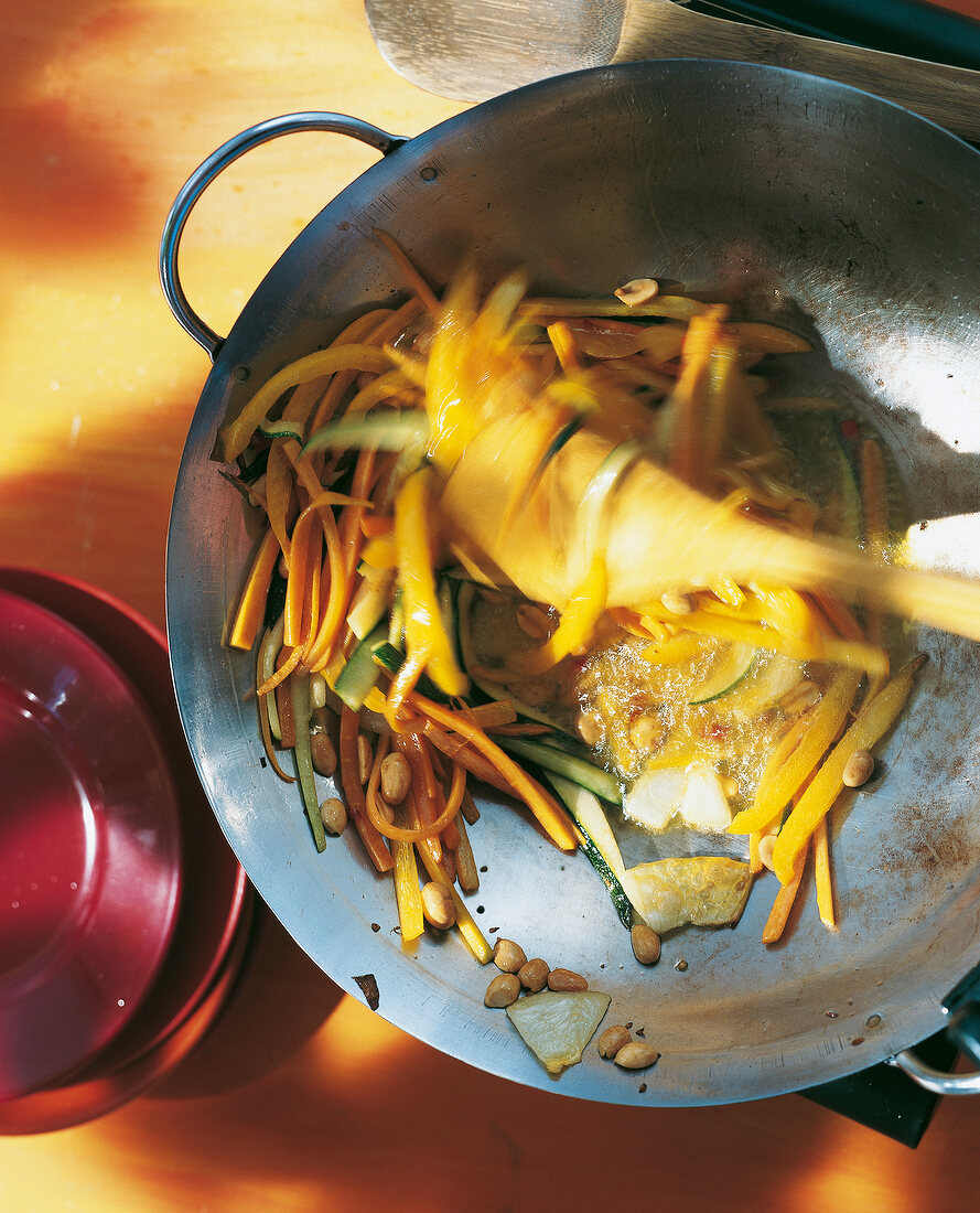 Wok with carrots, zucchini, peppers and peanuts