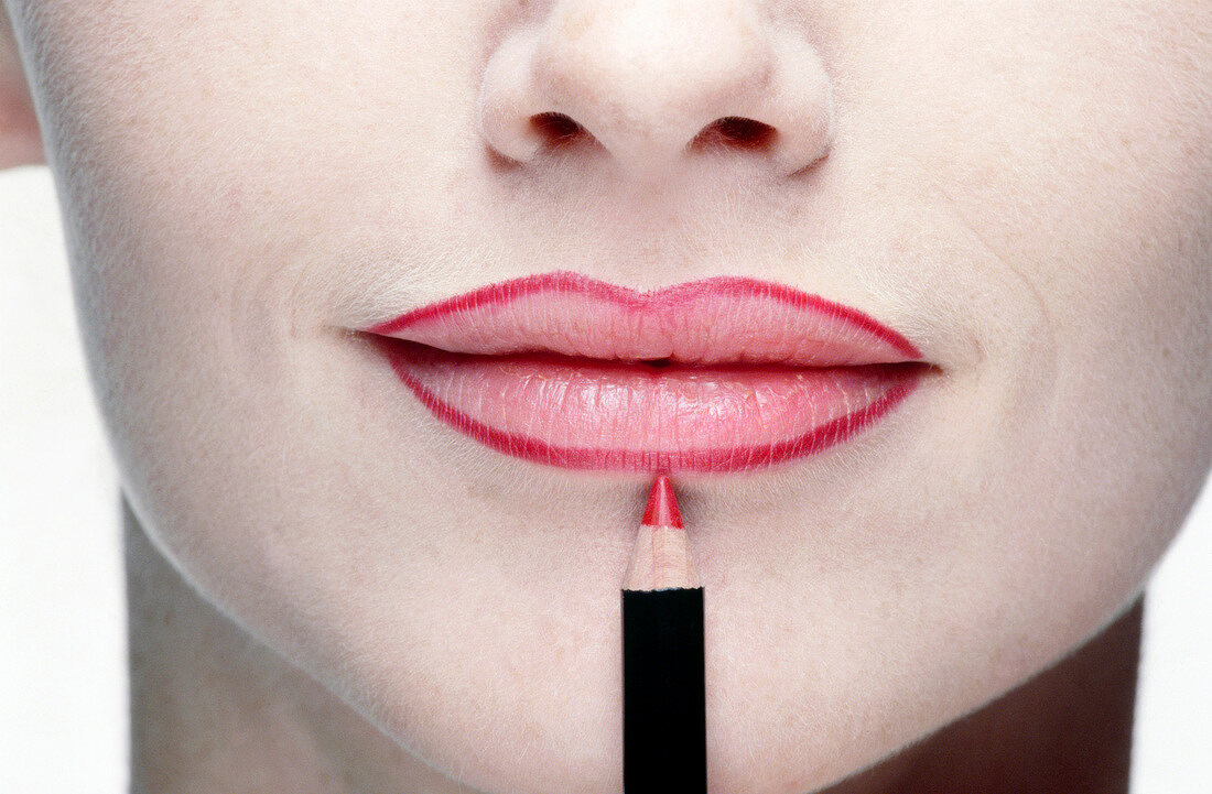 Close-up of woman wearing lip liner