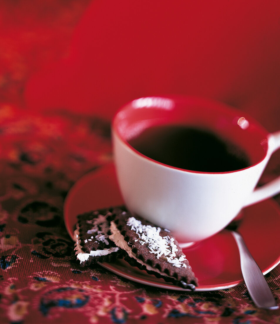 A cup of tea with two homemade cookies