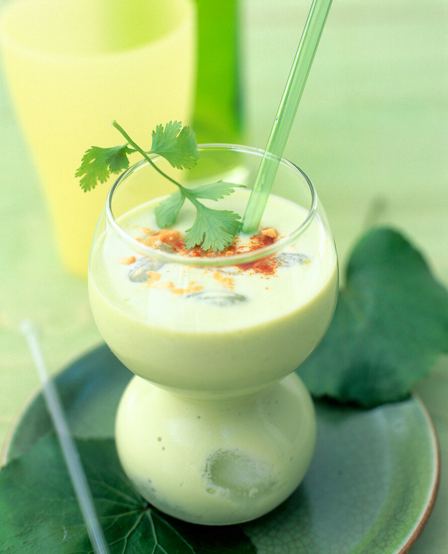 Avocado coconut shake with peanut pieces and coriander