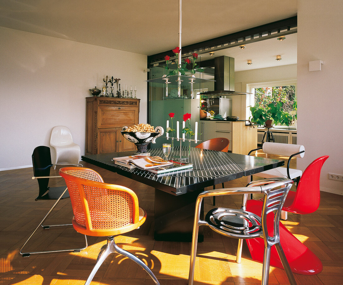 offene Wohnküche mit Designtisch,ver schiedenen Stühlen im Stilmix