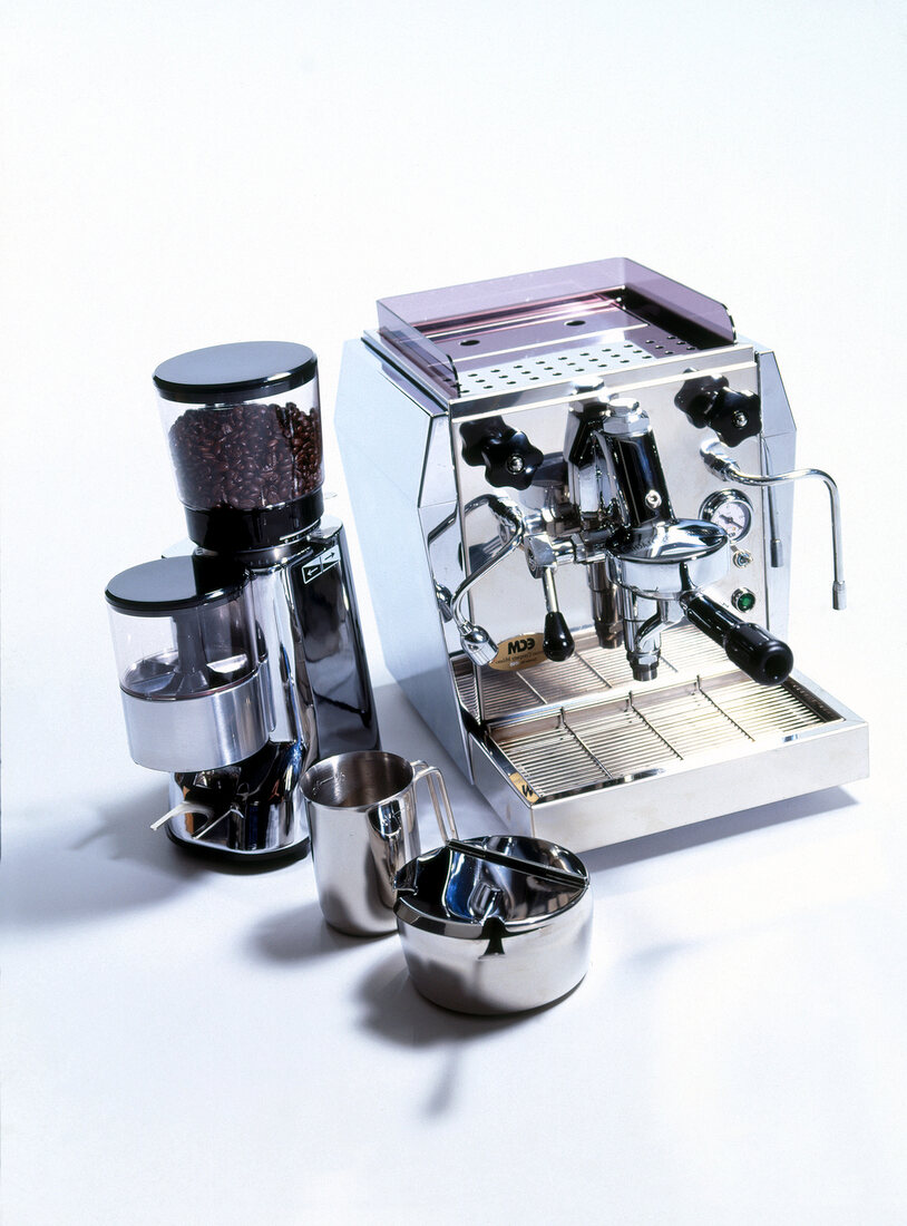 Latest technology chrome espresso machine and grinder on white background