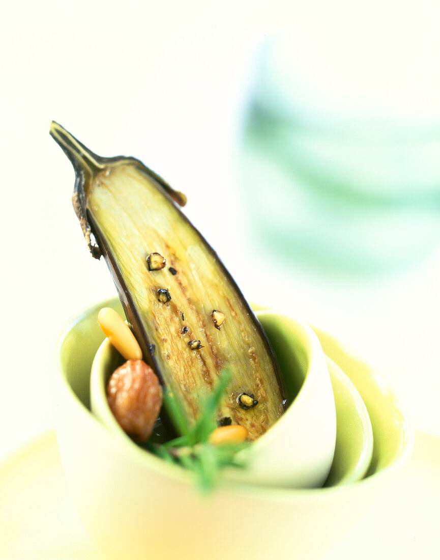 Close-up of baby eggplant with pine nuts and raisins