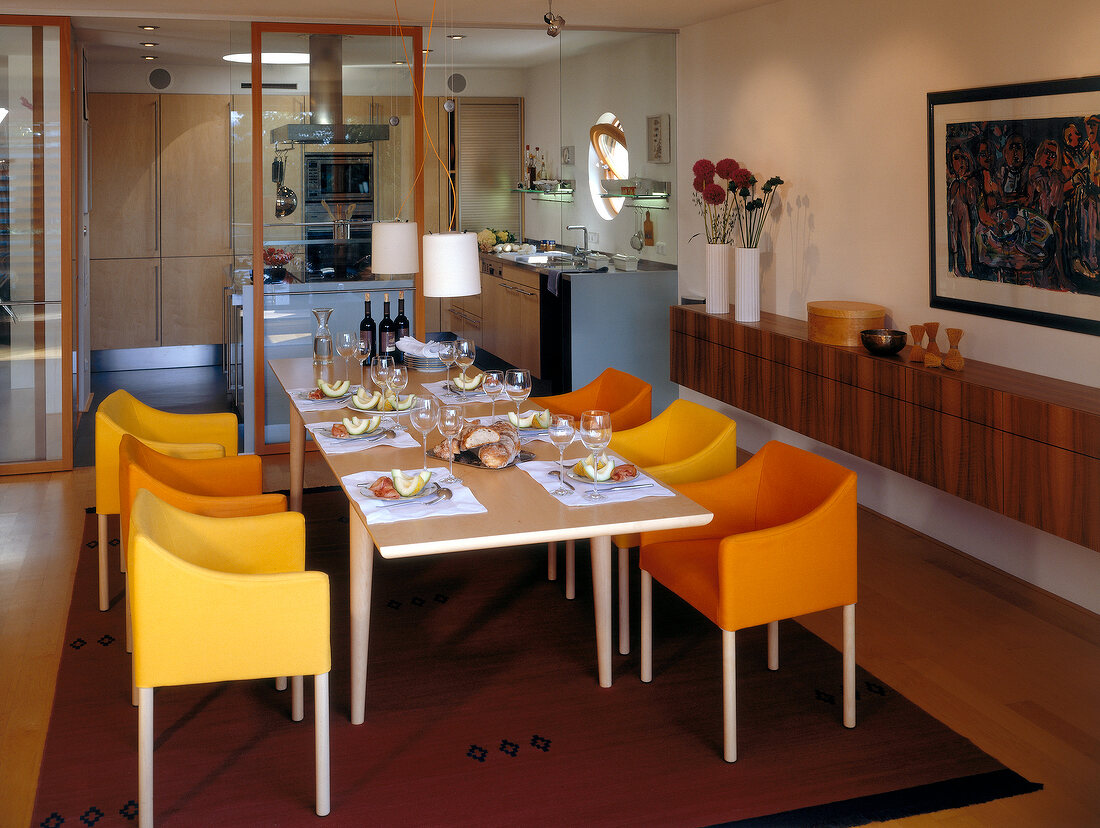 Long set dinning table with yellow chairs