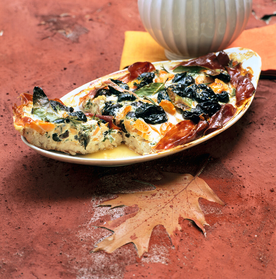 Meat tart with dried fruits on plate