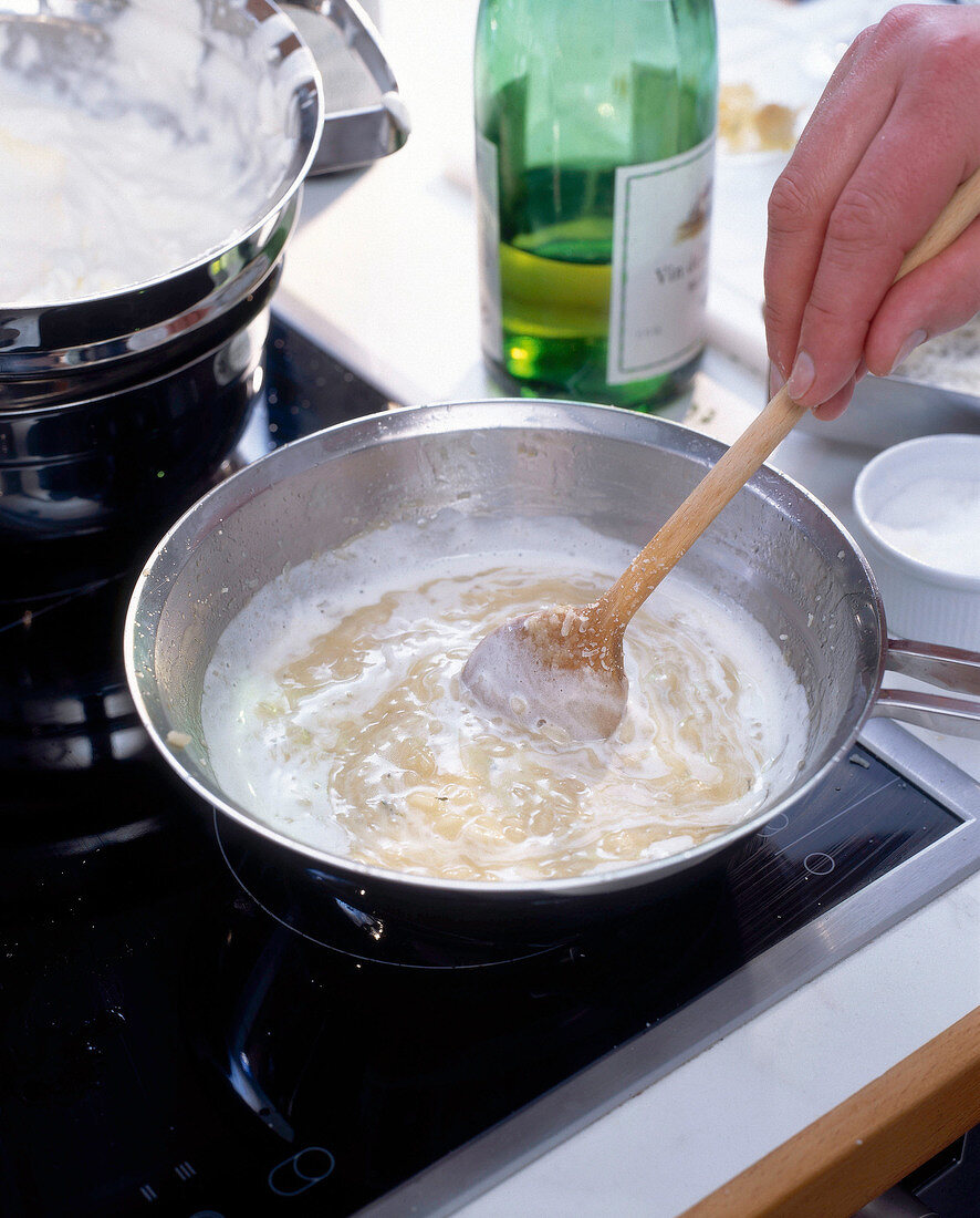 Whipped cream is added into rice while preparing Risotto