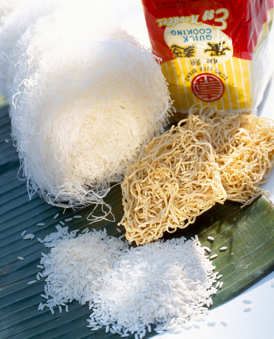 Close-up of rice, rice noodles and wheat noodles on banana leaf, Asian ingredients