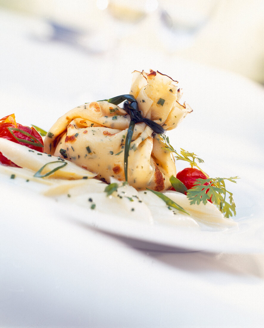 Close-up of herb pancake with asparagus and braised cherry tomatoes