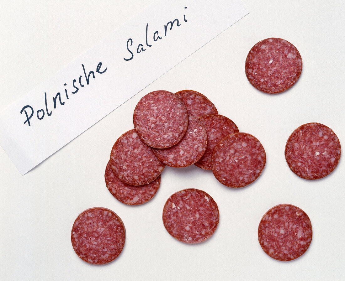 Slices of polish salami on white background