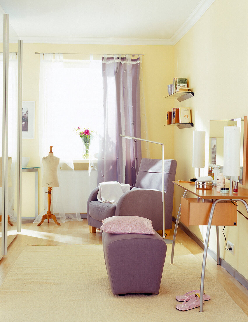 Dressing area with vanity table and purple armchair