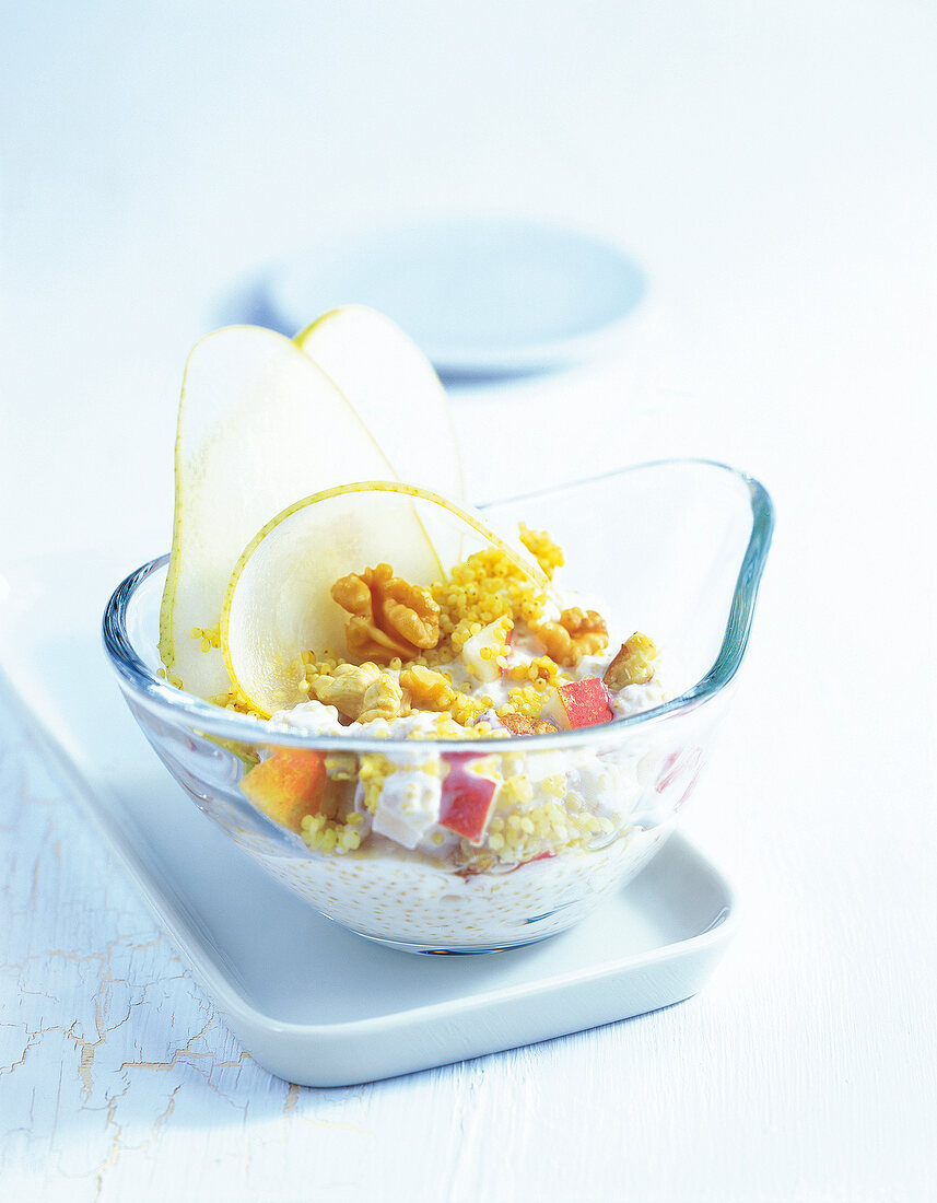 Bowl with quinoa, muesli and pear slices