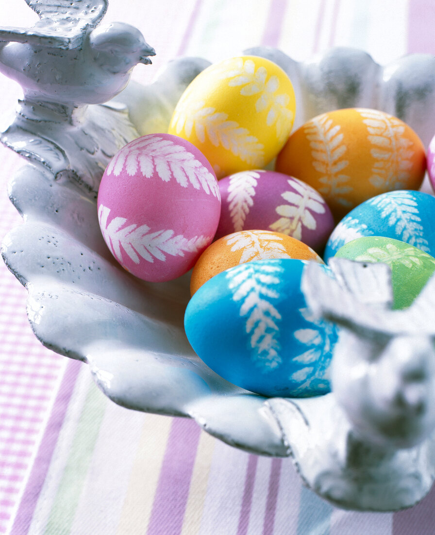 Close-up of multi-coloured painted Easter eggs in bowl