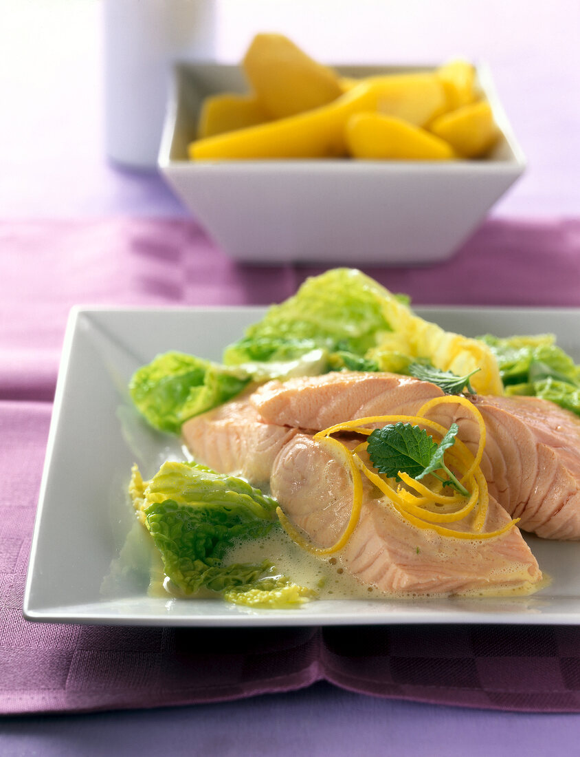 Salmon with savoy cabbage server on square plate