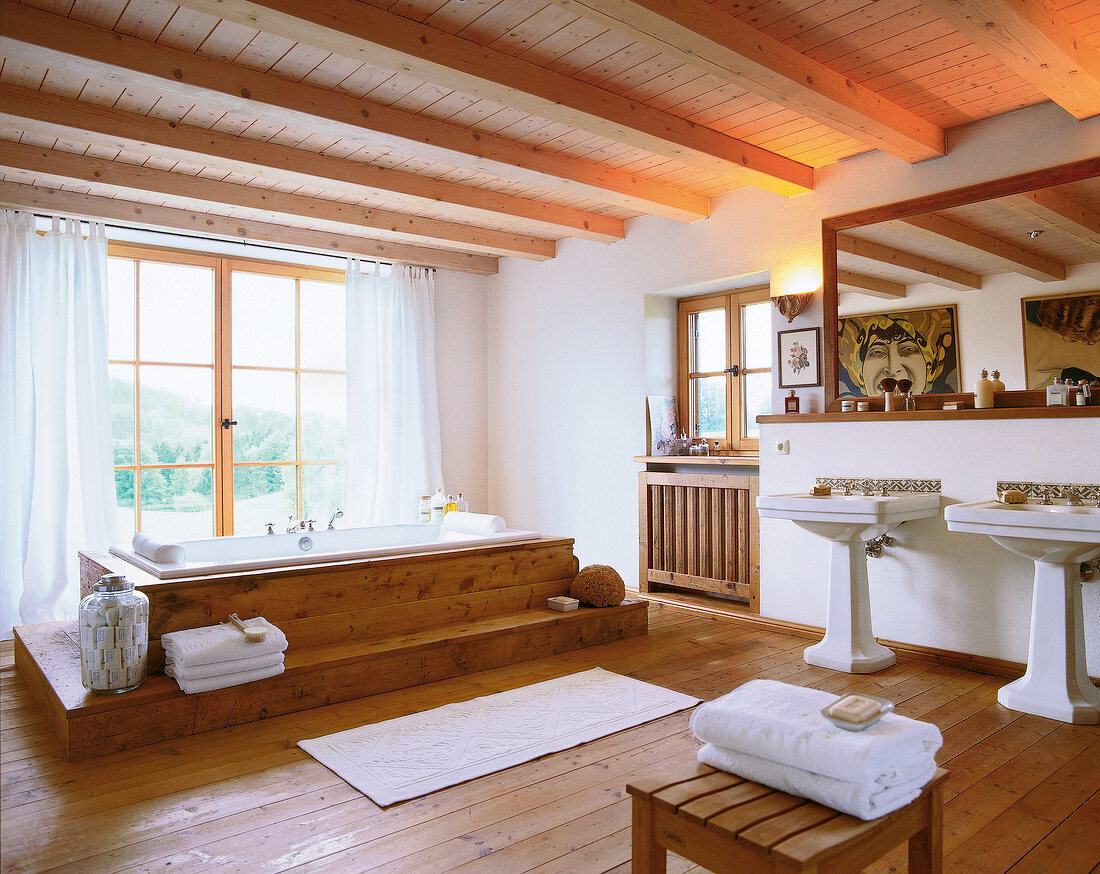 Rustic bathroom with wooden flooring, ceiling, and antique ceramic fittings