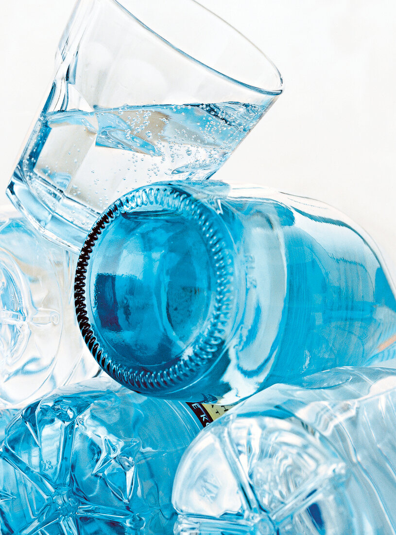 Close-up of mineral water bottles and glass of water