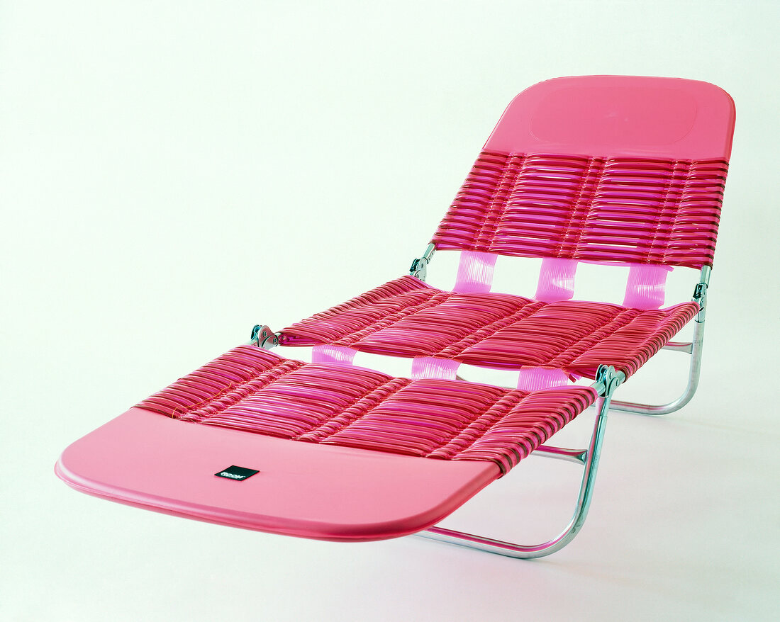 Pink deck chair with steel frame and plastic covering on white background