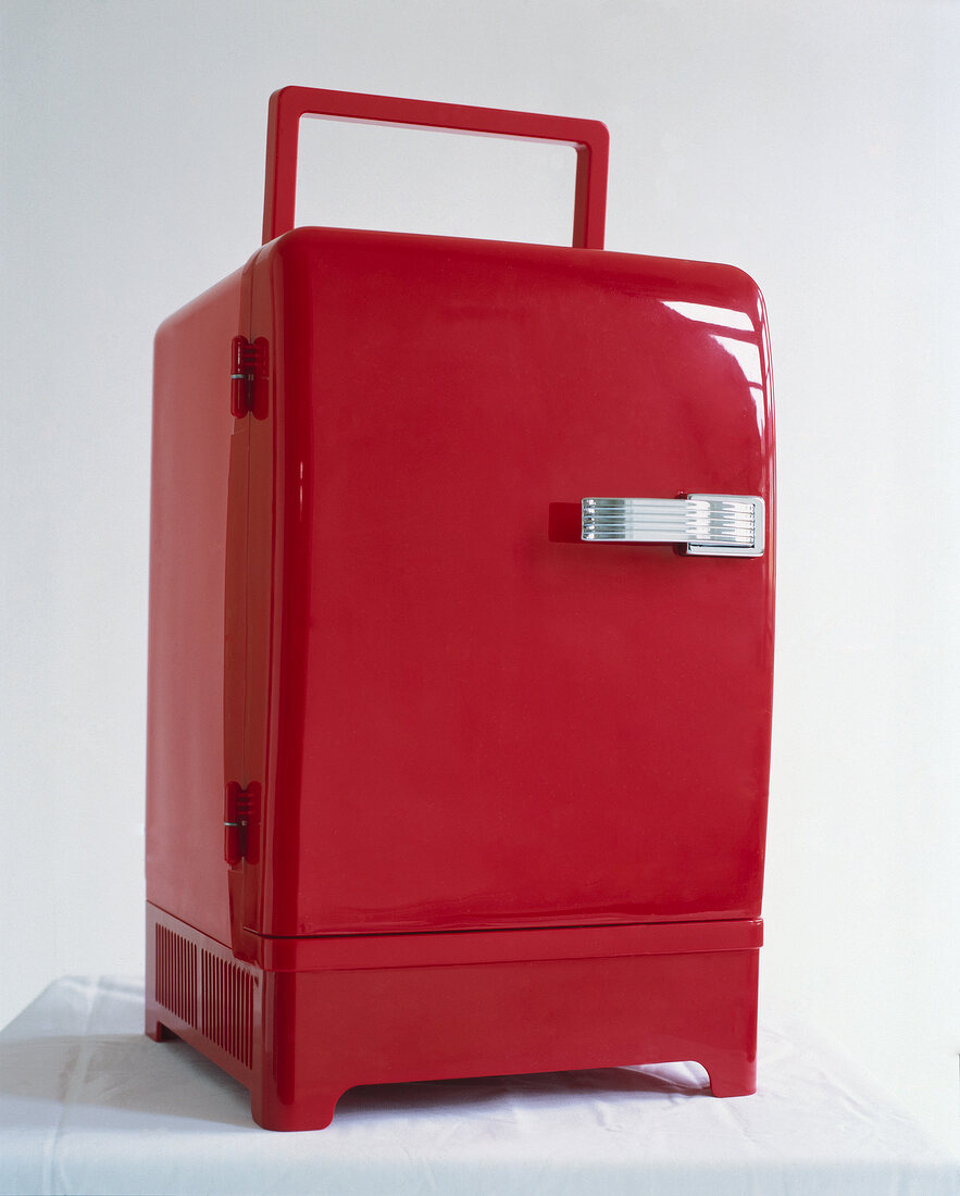 Close-up of red portable mini fridge on white background