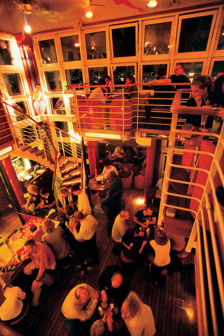 Guests at Tower Bar at Hotel Hafen in evening, Hamburg, Germany