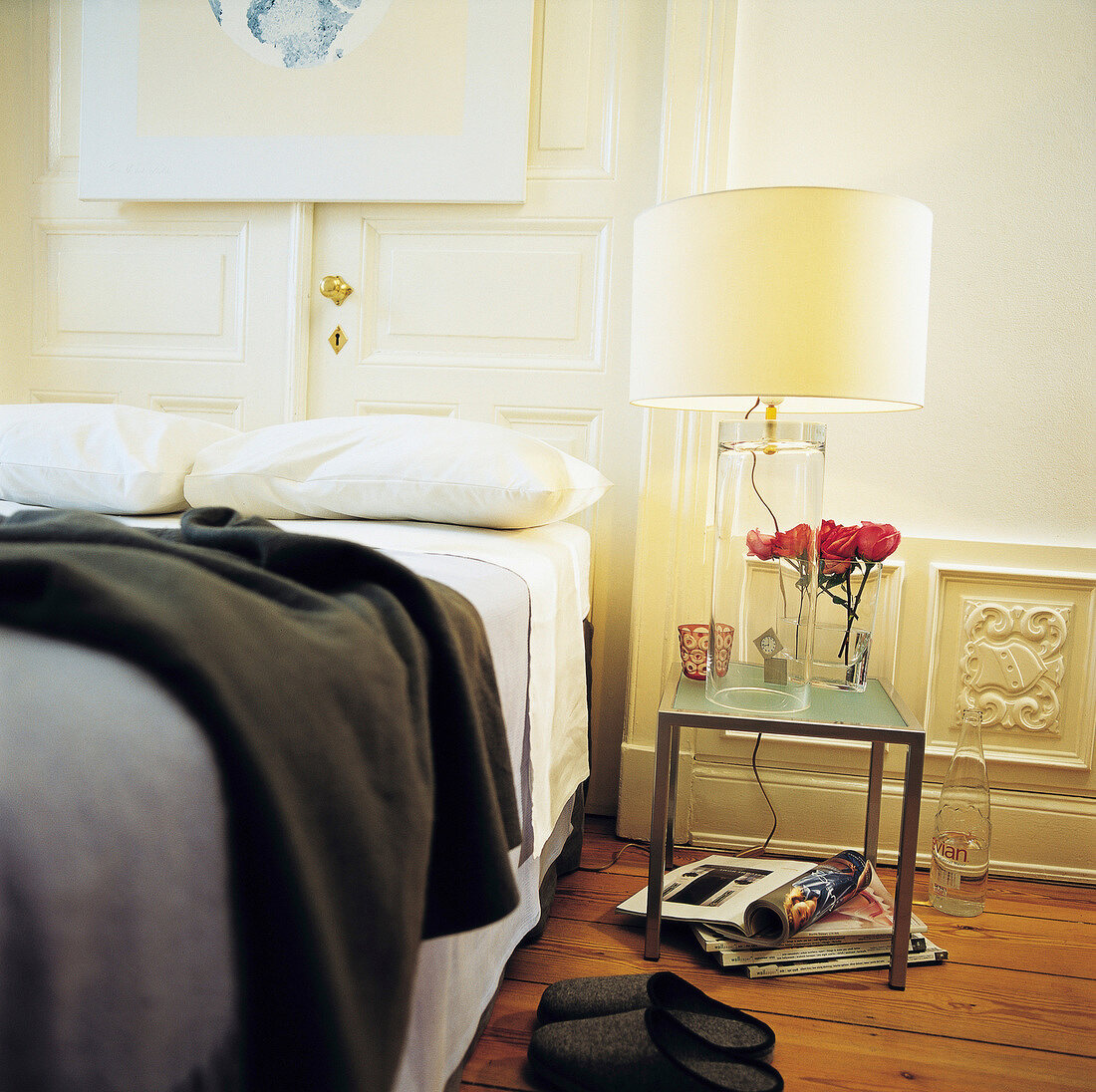 Illuminated lamp with glass cylinder foot in bedroom