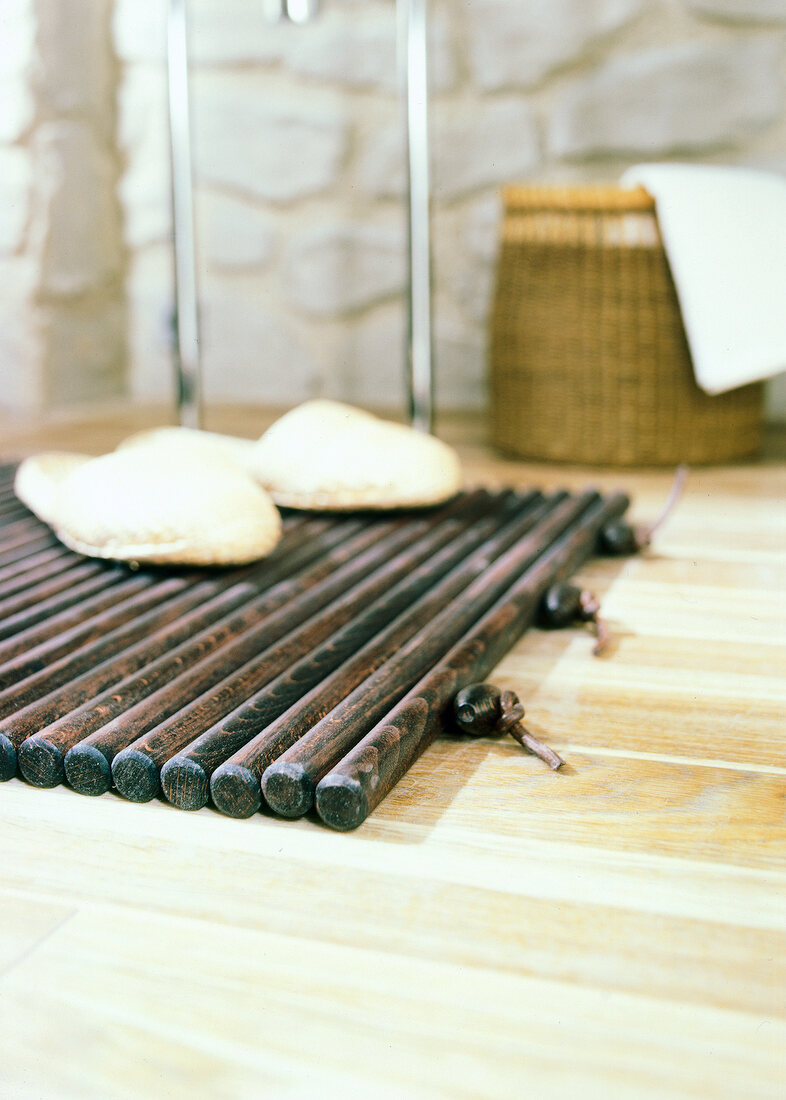 Close-up of slippers on wooden floor mat on parquet