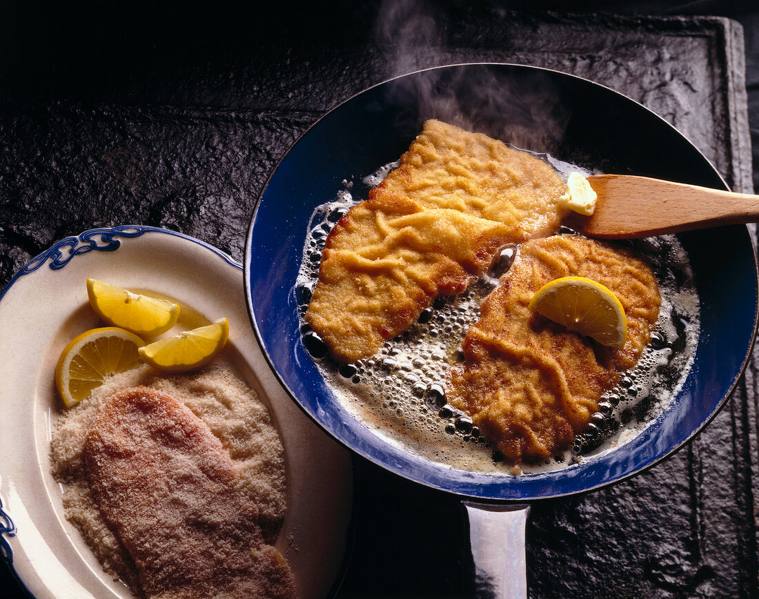 Close-up of wiener schnitzel in frying pan