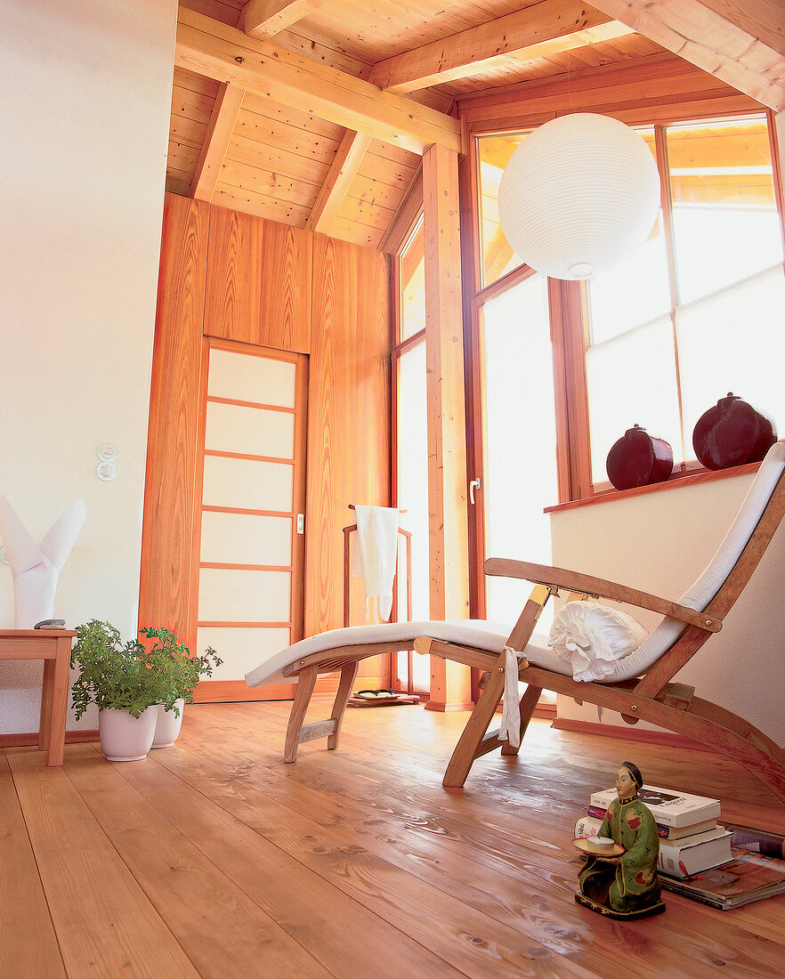 Wooden wall cladding and deck chair in living room