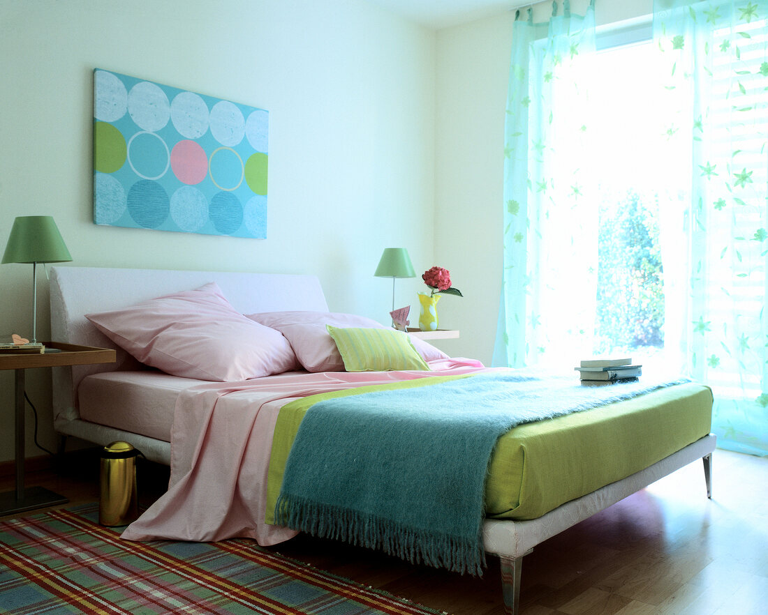 Bedroom with bed, fabric, blanket, checks carpet and curtains in pastels