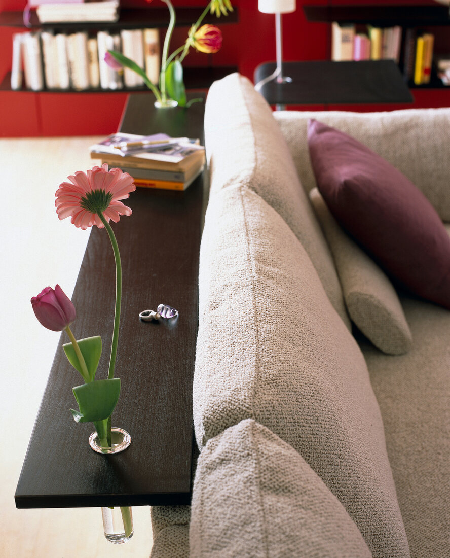 Brown wood tray at back of sofa