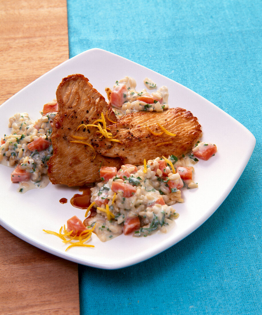 Turkey breast and carrot risotto on plate