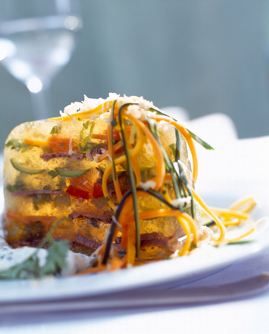 Close-up of jellied beef with vegetable spaghetti on plate