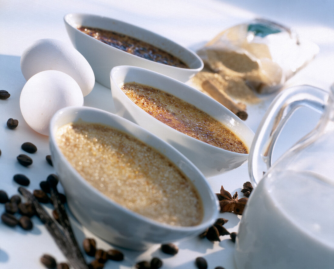 Different ingredients for preparing burnt cream in bowls on table