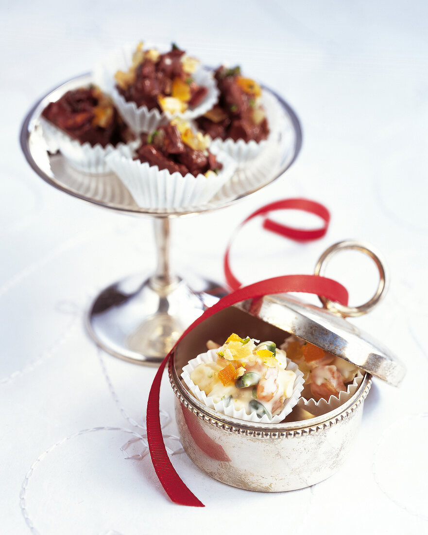 Fruit desserts in silver tin decorated with red ribbon