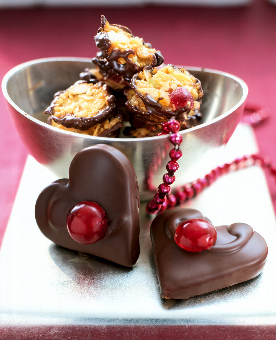 Heart shaped honey stuffed chocolates and florentine in silver bowl