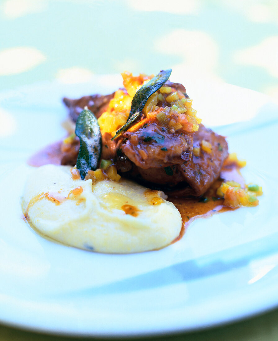 Close-up of rabbit's meat with pepper on plate