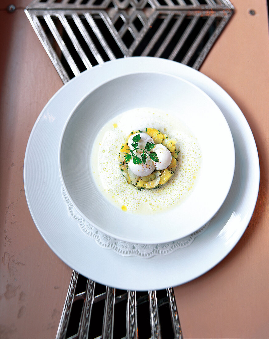 Potato and leek soup with haddock in bowl