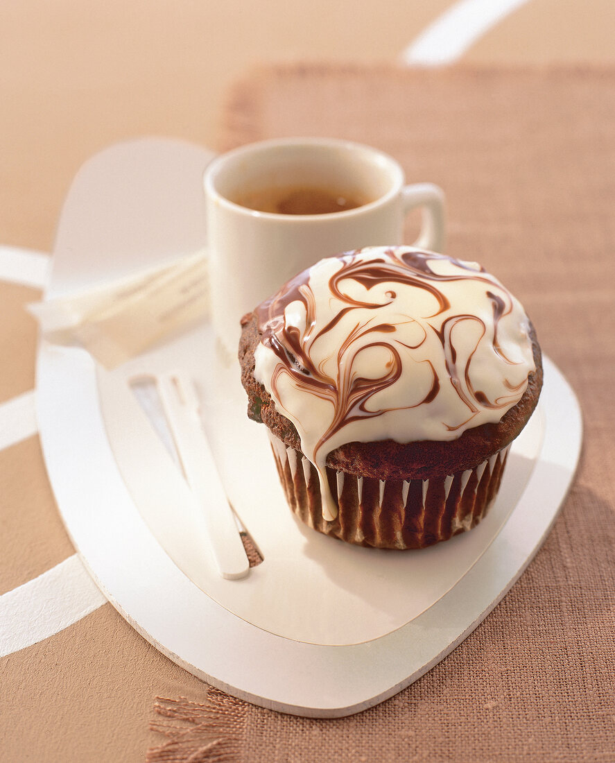 Close-up of baileys muffin with coffee on plate