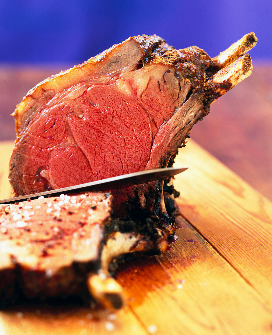 Close-up of cooked beef sliced on chopping board