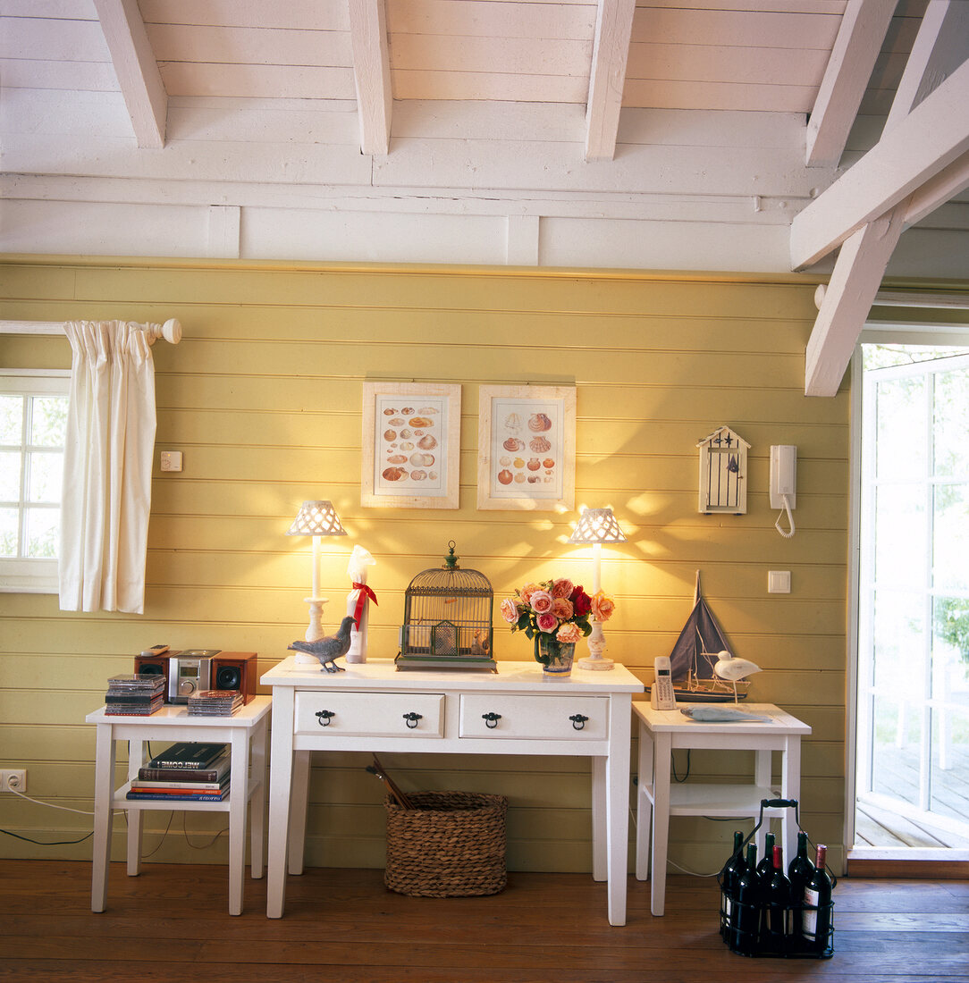 Side table with maritime accessories against yellow wall