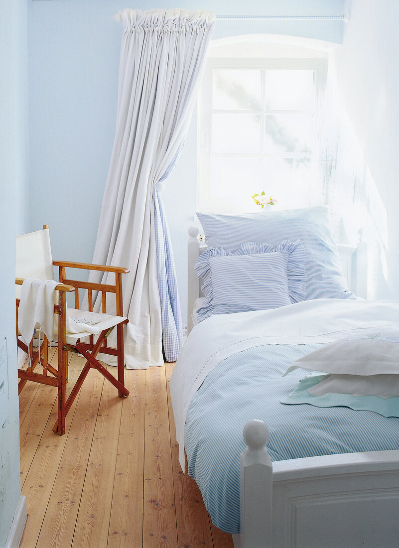 Blue bedroom with wooden floor