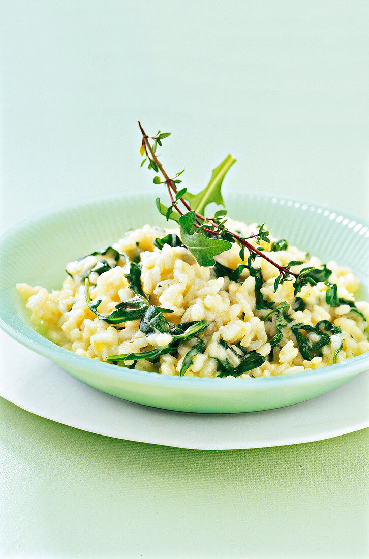 Close-up of risotto with rocket salad in bowl