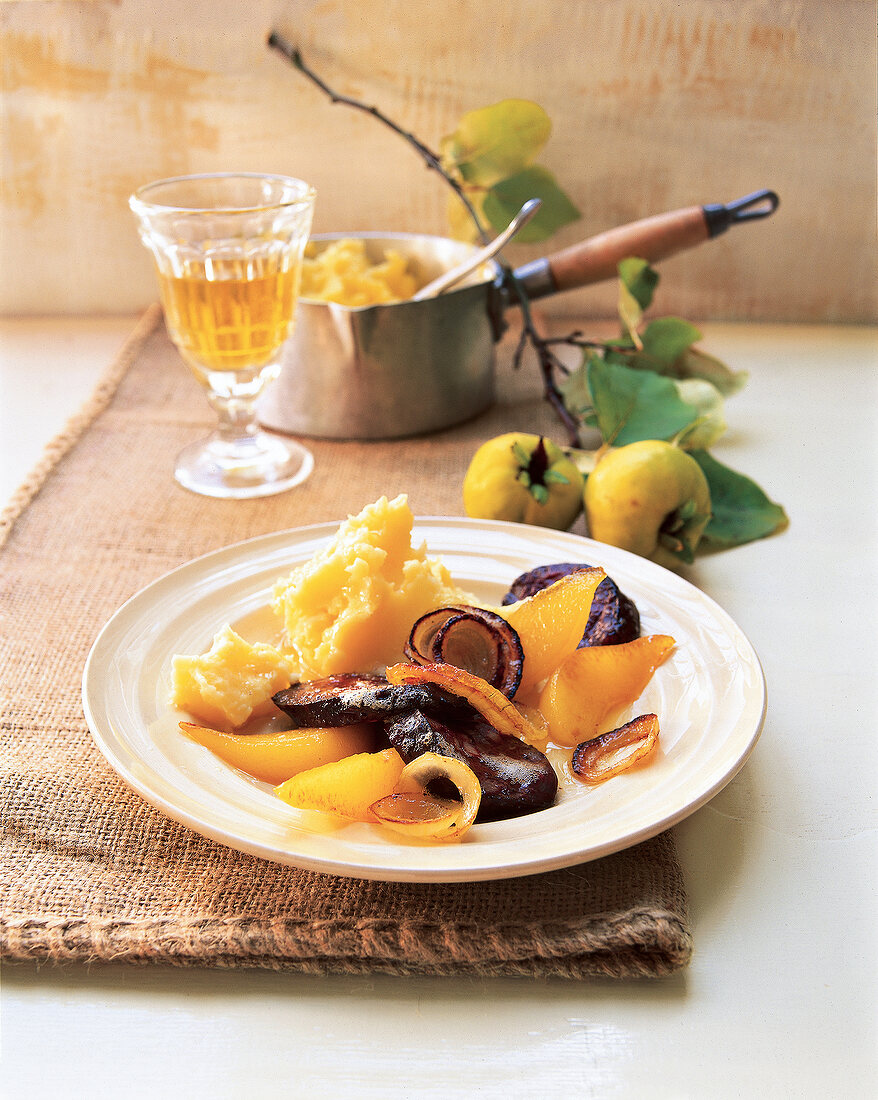 Kartoffeluree with blood sausage and quince on plate