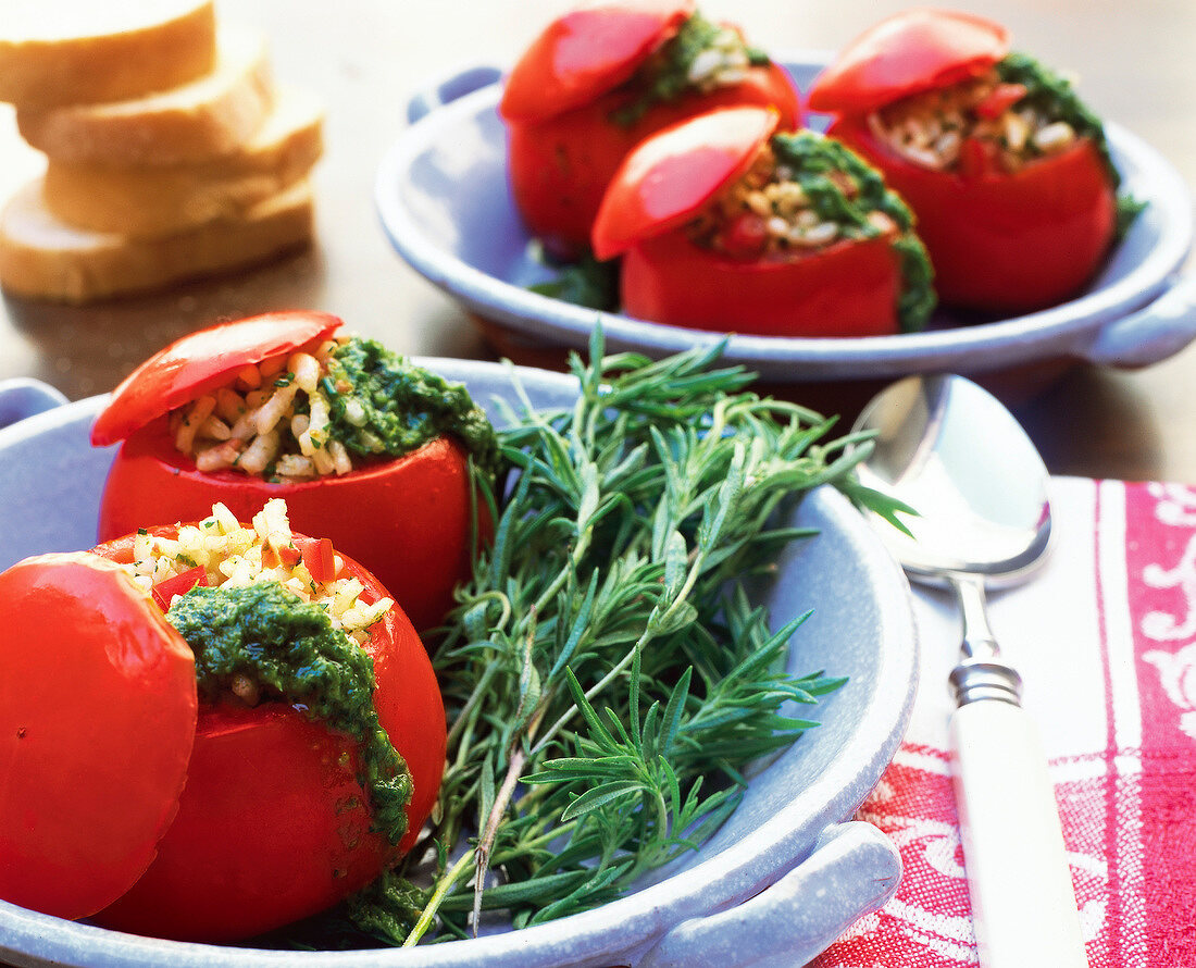 Close-up of stuffed tomatoes with rice and pesto in casserole