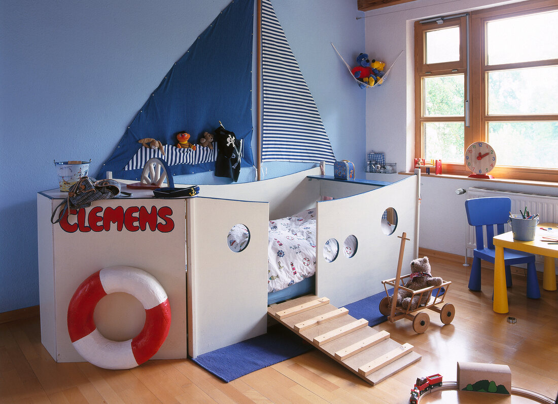 Children's room with ship shaped bed and toys around
