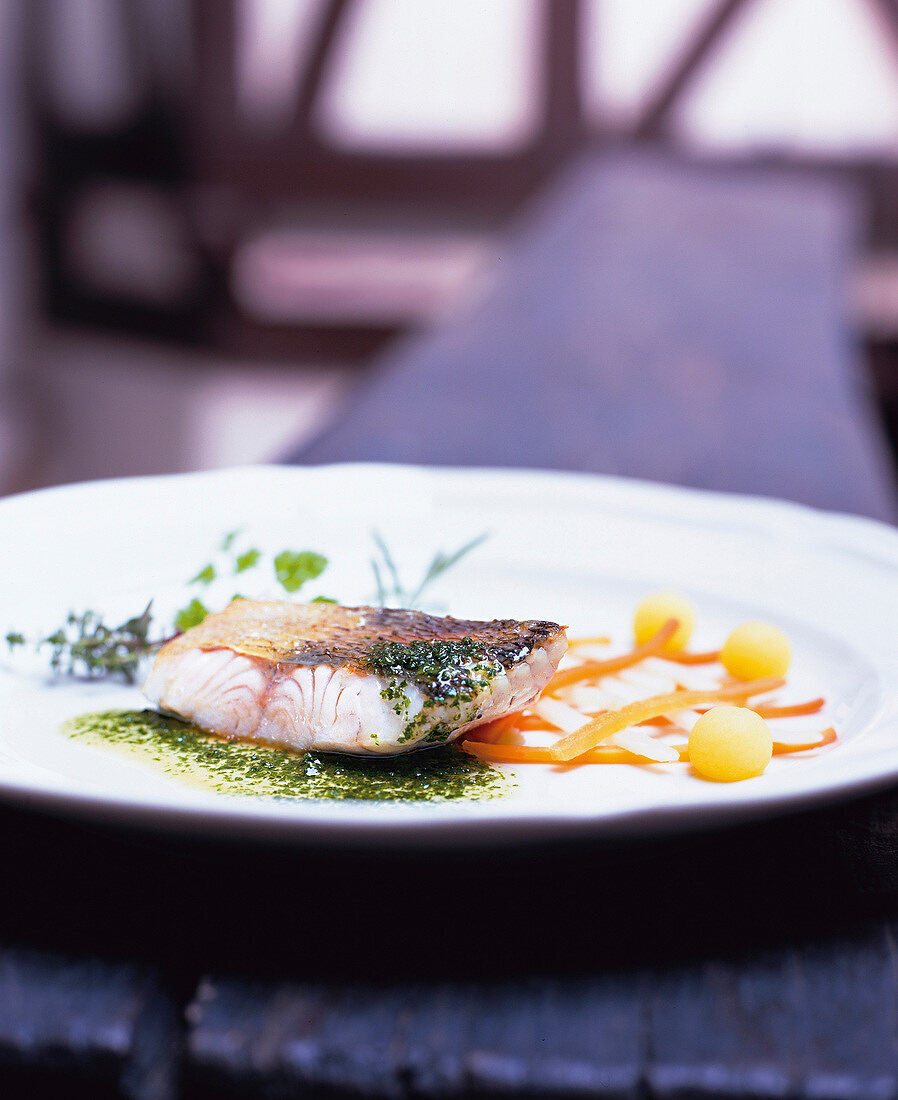 Close-up of zander fillet with vegetables on plate